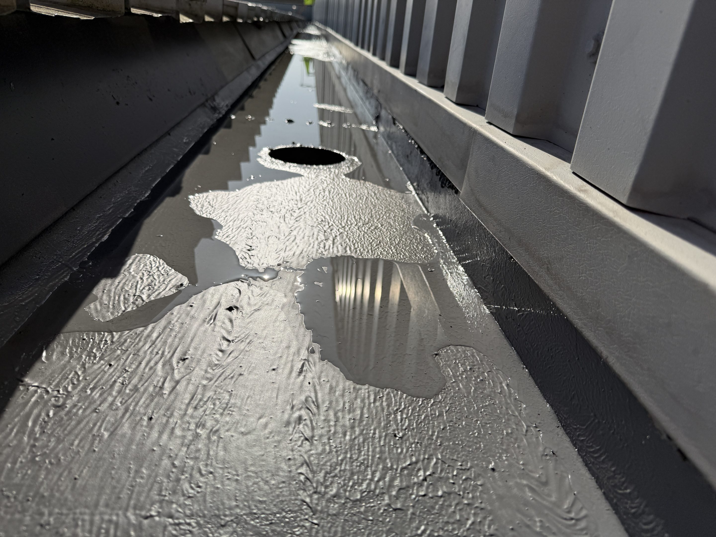 Image showing Liquasil's liquid gutter lining system, Gutterseal applied to a steel gutter on an industrial unit