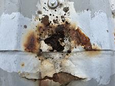 severe cut edge corrosion beneath an existing cut edge corrosion treatment