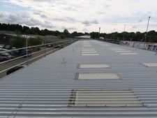 image showing a metal roof coating project using Liquasil's Metalseal 20
