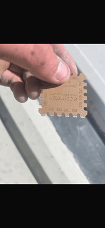 Image showing a wet film comb being used on a Liquasil metal roof coating project